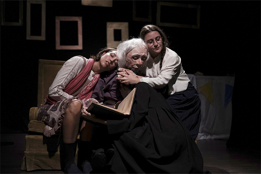Two young people with a puppet representing the father